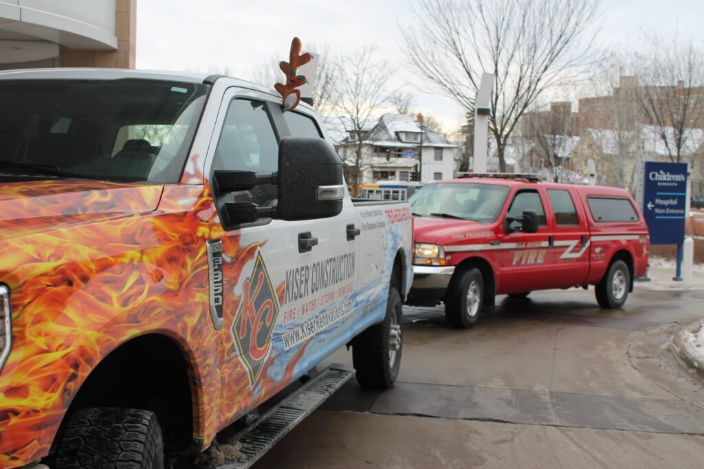 kiser construction and elk river fire foundation delivering toys to children's mn