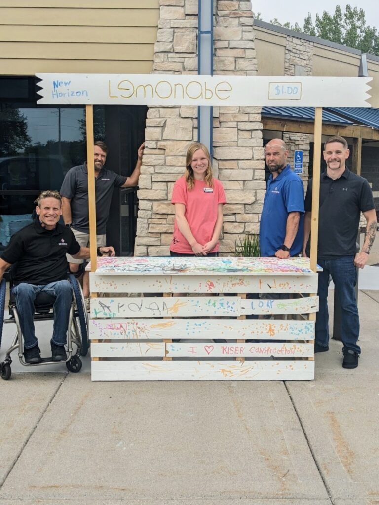 kiser construction crew donating lemonade stand to new horizon academy in elk river