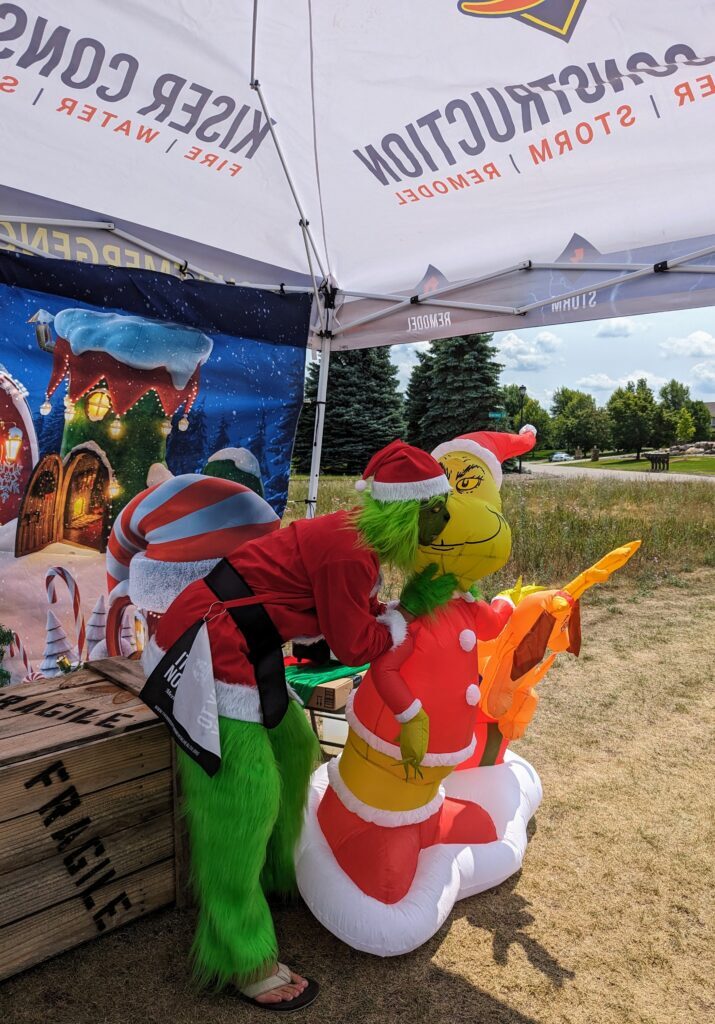 the grinch at the kiser construction christmas trees and tees photo booth